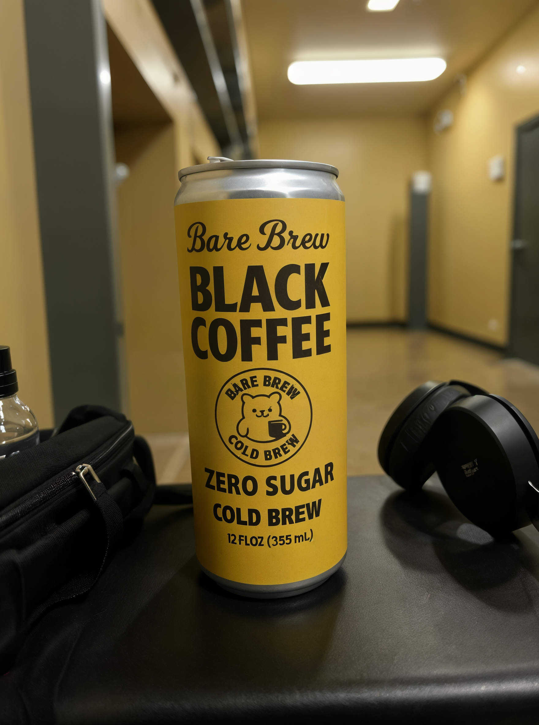 Bare Brew Cold Brew Coffee can on gym bench with headphones and water bottle